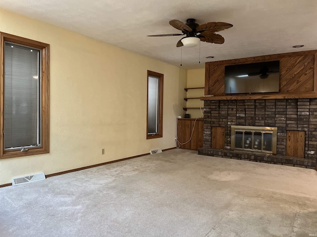 unfurnished living room with a fireplace, carpet flooring, visible vents, and baseboards