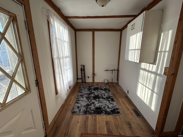 interior space with light wood finished floors and visible vents