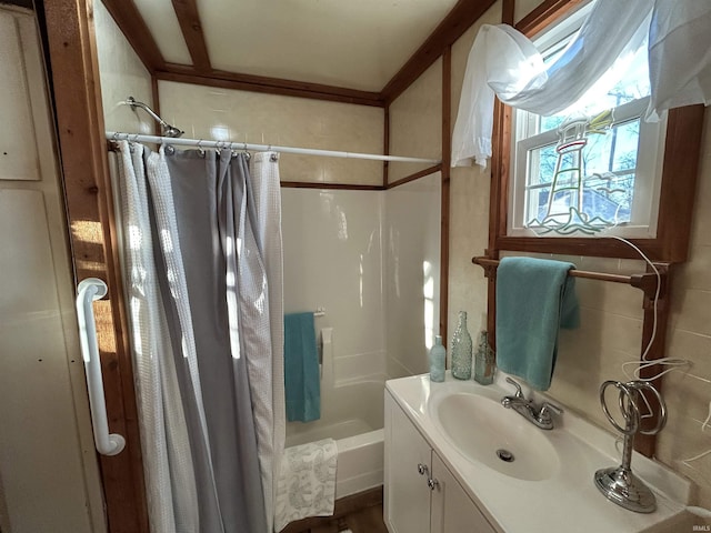 full bathroom featuring shower / bath combo with shower curtain and vanity