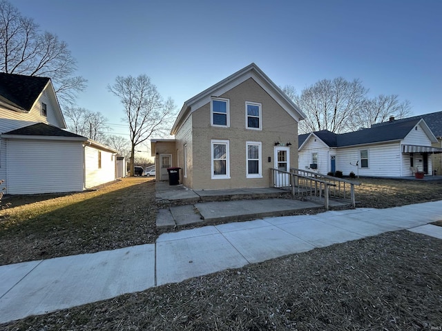 traditional-style home with brick siding