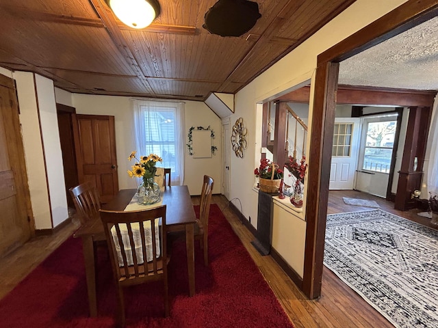 dining space featuring a wealth of natural light, wooden ceiling, baseboards, and wood finished floors