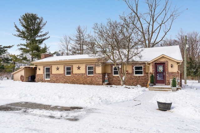 ranch-style house with brick siding and a chimney