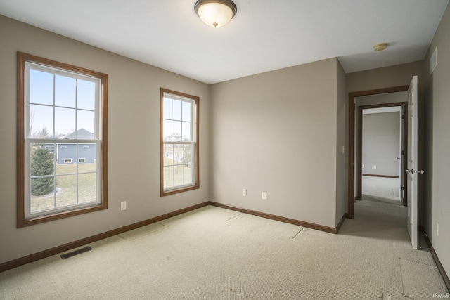 unfurnished room featuring light carpet, baseboards, and visible vents