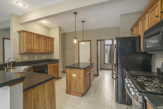 kitchen with brown cabinetry, dark countertops, a kitchen island, black appliances, and a sink