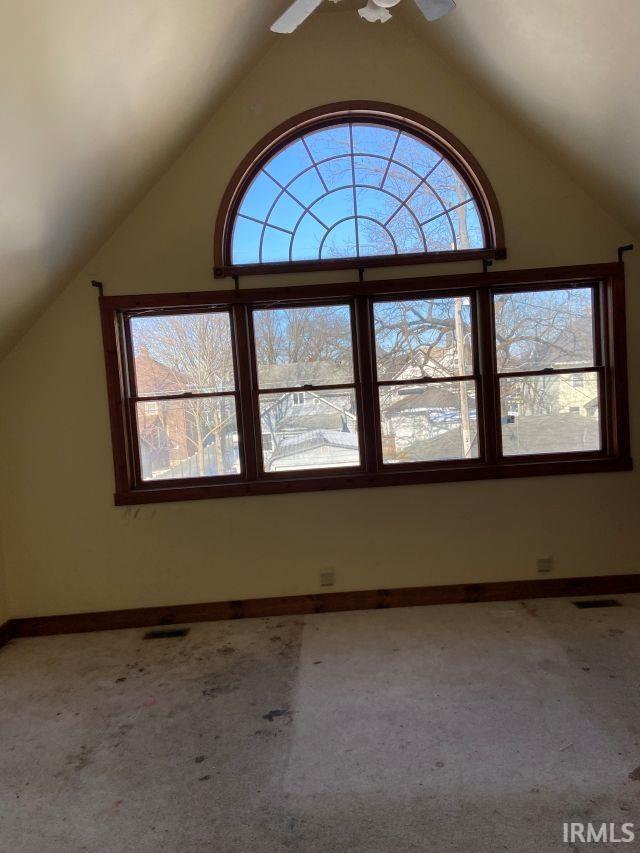 bonus room featuring vaulted ceiling, carpet floors, visible vents, and baseboards