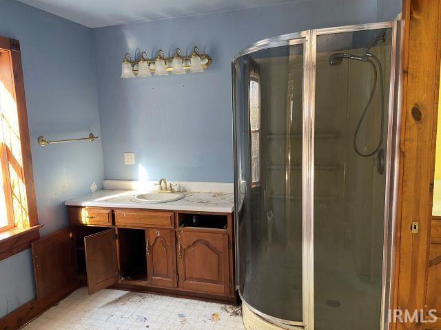 bathroom featuring a shower stall, vanity, and tile patterned floors