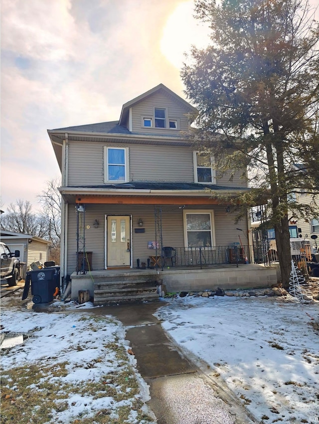 american foursquare style home featuring a porch