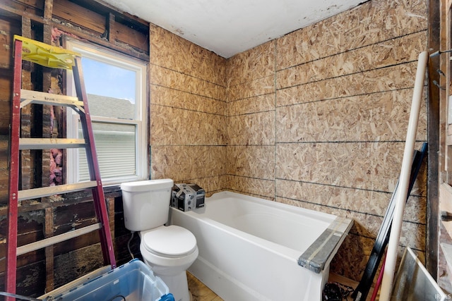 full bathroom with a bath and toilet