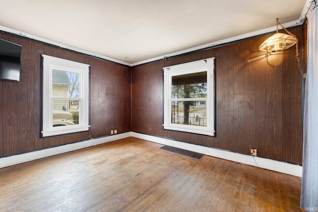 empty room with visible vents and wood finished floors