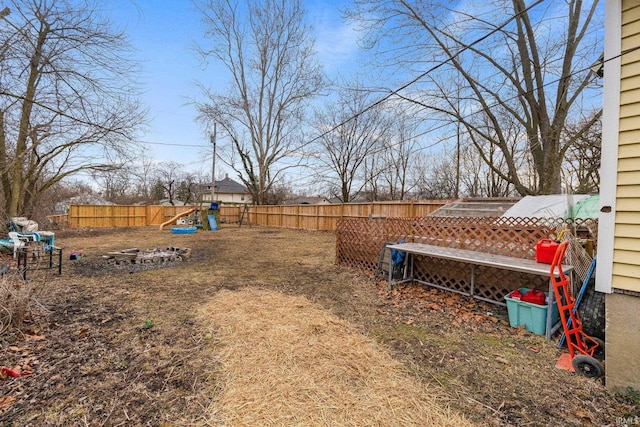 view of yard with a fenced backyard and a playground