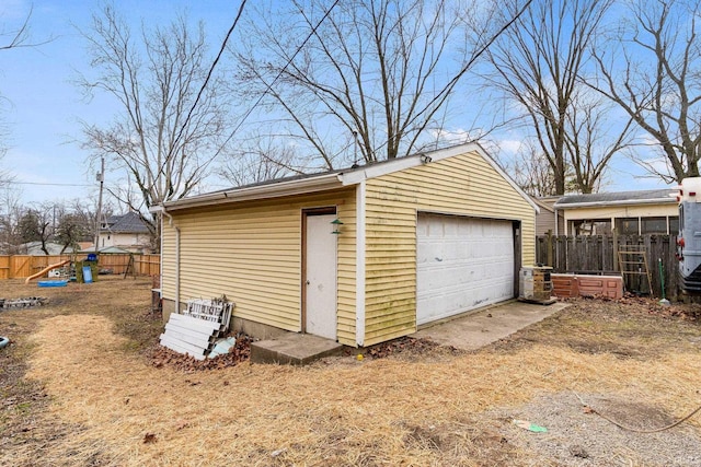 detached garage featuring fence