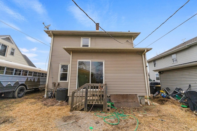 back of house featuring cooling unit