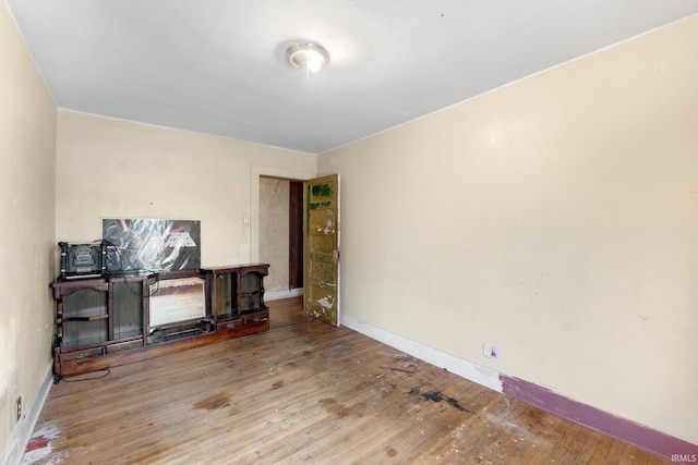 interior space with baseboards and hardwood / wood-style flooring