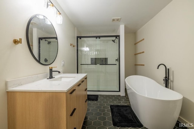 full bathroom with a freestanding tub, visible vents, a shower stall, and vanity