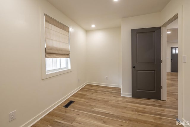 spare room featuring recessed lighting, light wood-type flooring, visible vents, and baseboards