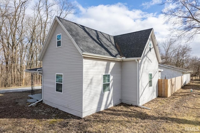 view of home's exterior with a shingled roof