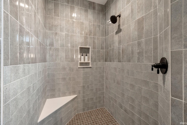 bathroom with a tile shower