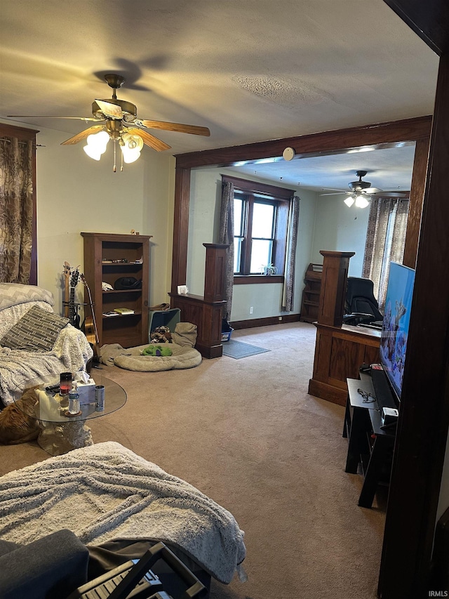 carpeted bedroom with ceiling fan and baseboards