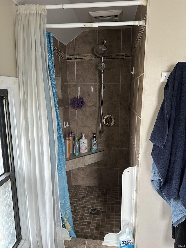 bathroom featuring a shower stall and visible vents