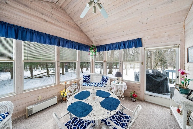 sunroom with lofted ceiling, wood ceiling, a healthy amount of sunlight, and ceiling fan