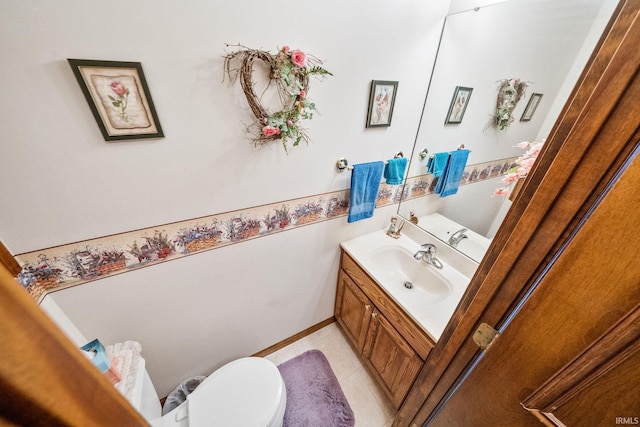 half bathroom featuring toilet, tile patterned flooring, and vanity