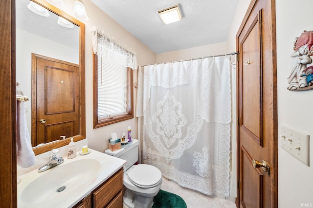 full bathroom with toilet, curtained shower, a textured ceiling, and vanity