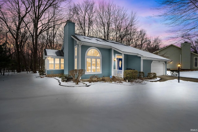 view of front of home with a garage and a chimney