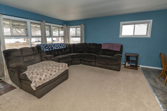 carpeted living area with baseboards