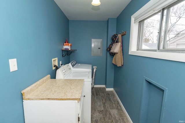 clothes washing area featuring laundry area, baseboards, electric panel, wood tiled floor, and washing machine and clothes dryer