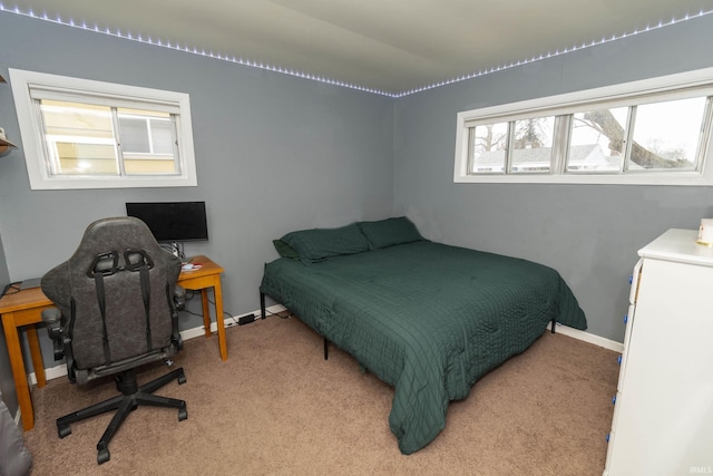 bedroom featuring light carpet and baseboards