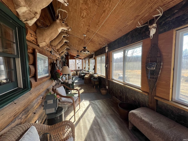 sunroom / solarium with lofted ceiling, a water view, and wood ceiling