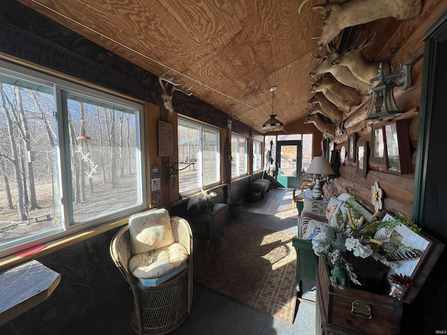 sunroom / solarium featuring lofted ceiling and wooden ceiling