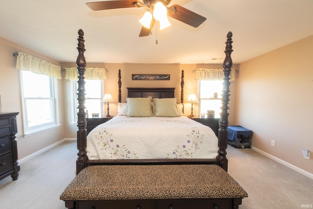 carpeted bedroom with baseboards and a ceiling fan