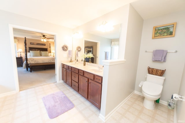 ensuite bathroom with double vanity, toilet, ensuite bathroom, tile patterned floors, and a sink