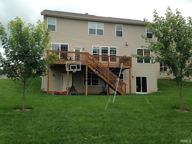 back of house with stairway, a lawn, and a wooden deck