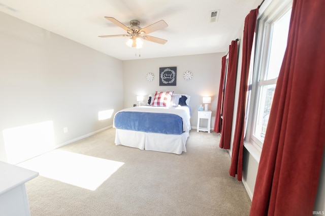 bedroom featuring carpet floors, visible vents, baseboards, and a ceiling fan