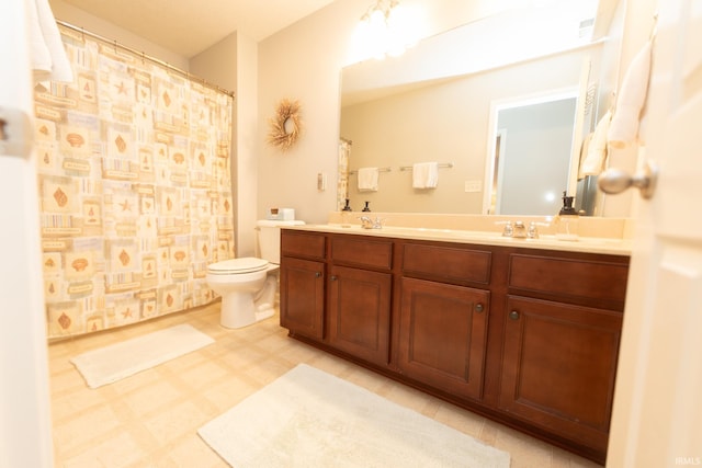 full bathroom with tile patterned floors, a sink, toilet, and double vanity