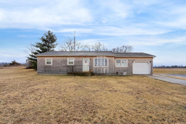 ranch-style home featuring a garage, driveway, and a front lawn