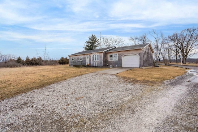 ranch-style home featuring a garage, concrete driveway, and a front lawn