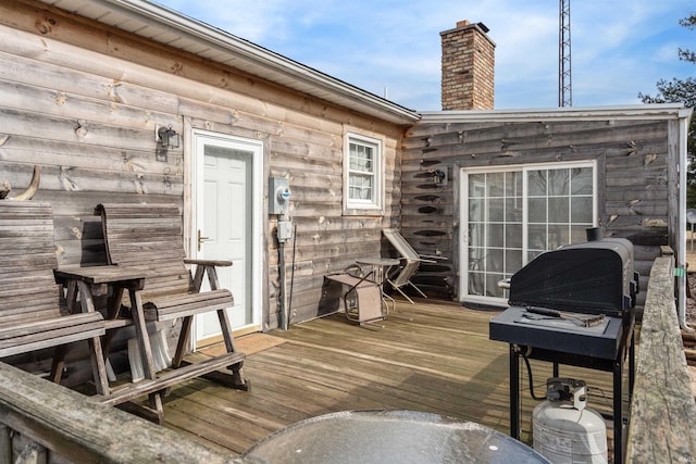 wooden deck featuring a grill