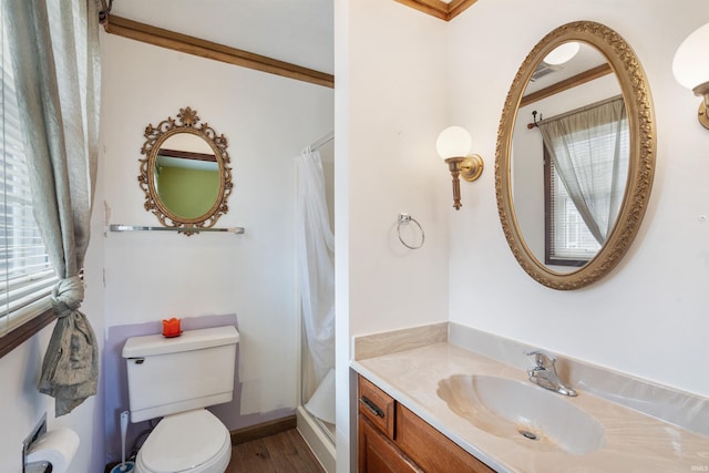 bathroom featuring crown molding, a shower with shower curtain, toilet, vanity, and wood finished floors