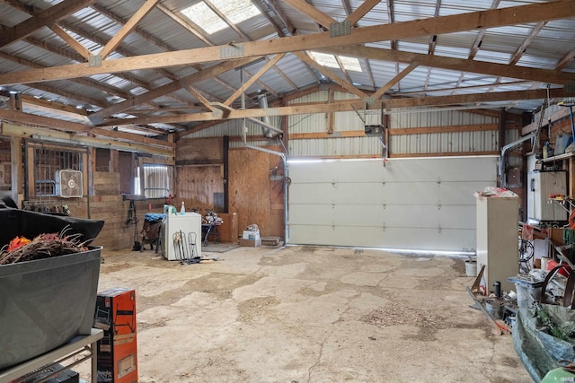 garage with a garage door opener and metal wall