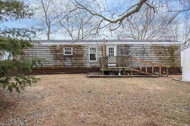 rear view of house featuring a wooden deck