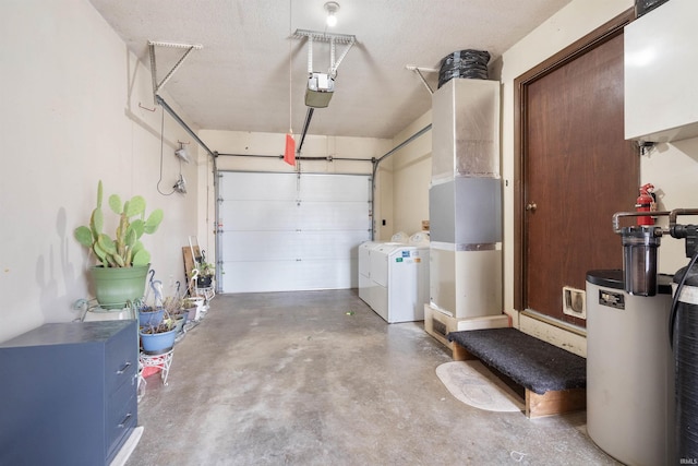 garage with washing machine and dryer and a garage door opener