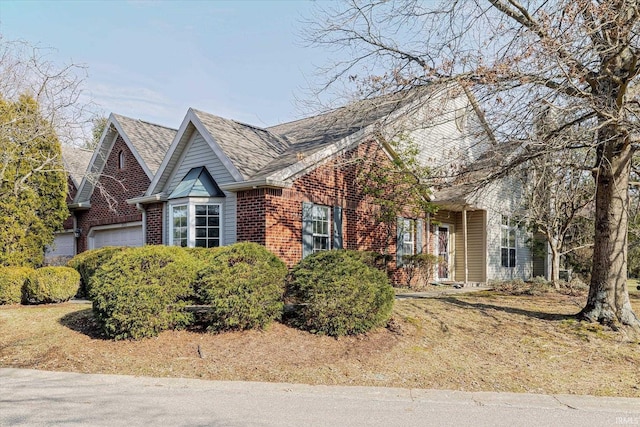 view of front of house with brick siding and an attached garage