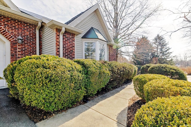 view of side of property with brick siding