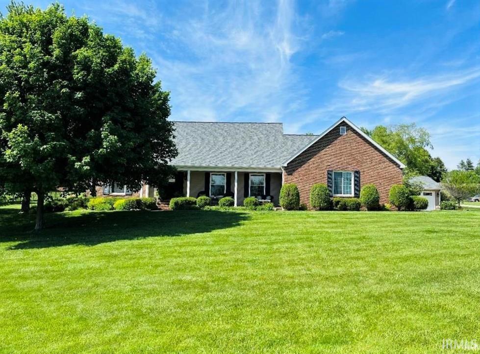 single story home with brick siding and a front lawn