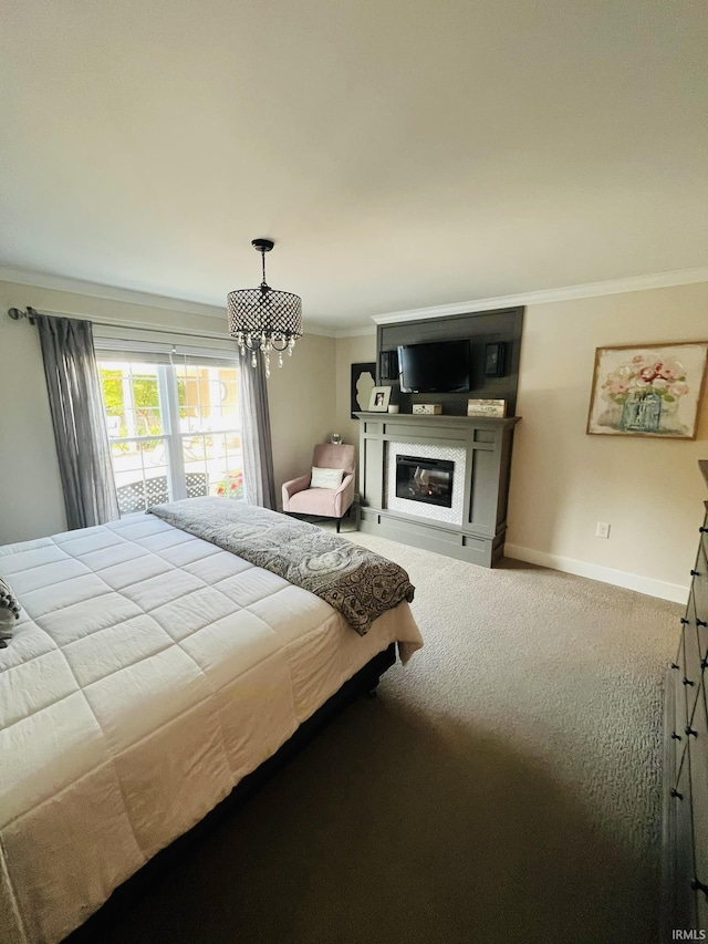 carpeted bedroom featuring baseboards, ornamental molding, and a glass covered fireplace