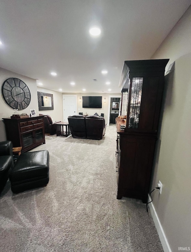 living room featuring carpet, baseboards, and recessed lighting