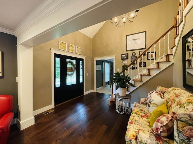 foyer entrance featuring visible vents, ornamental molding, wood finished floors, baseboards, and stairs